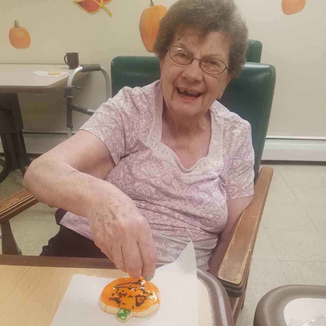 Image old woman decorating Halloween cookies at Kadima at Lakeside Nursing and Rehabilitation Facility