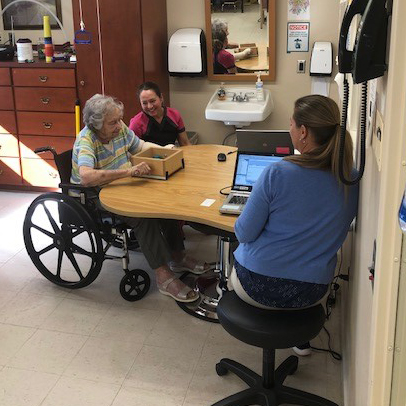 Image of woman in wheelchair and staff at Kadima at Lititz Nursing and Rehabilitation Facility
