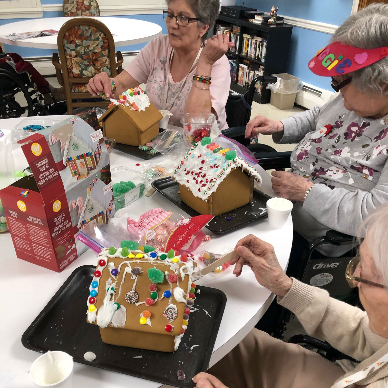 Image of women making gingerbread houses at Kadima at Pottstown Nursing and Rehabilitation Facility